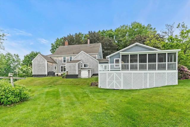 261 Main Ave, South Hampton, NH 03827 - back of house featuring a sunroom, a lawn, and a chimney