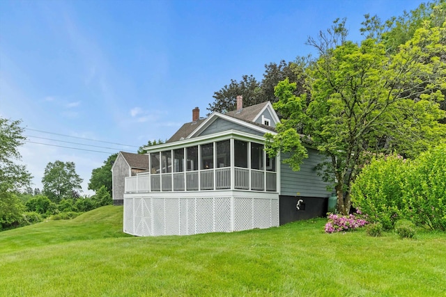 261 Main Ave, South Hampton, NH 03827 - rear view of house featuring a sunroom, a yard, and a chimney