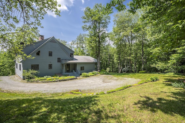 3440 Rte 44, West Windsor, VT 05037 - back of house featuring a chimney, a yard, and dirt driveway