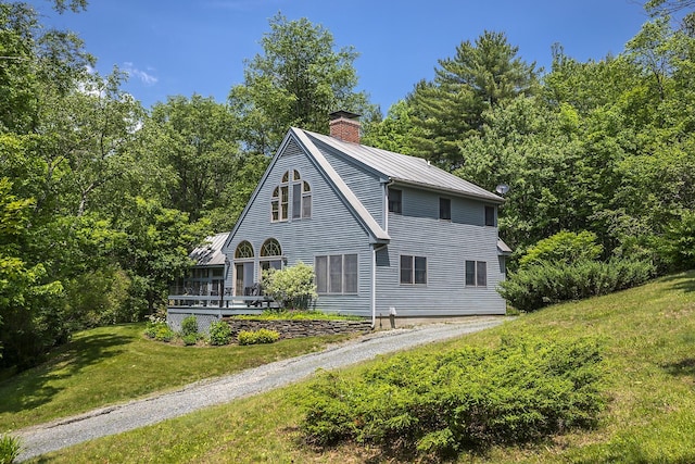 3440 Rte 44, West Windsor, VT 05037 - view of front of house featuring a chimney, a front lawn, a metal roof, and a wooden deck