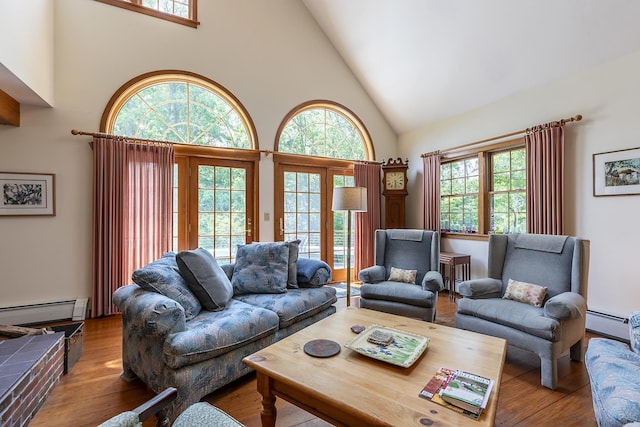 3440 Rte 44, West Windsor, VT 05037 - living area featuring high vaulted ceiling, baseboard heating, wood finished floors, and plenty of natural light