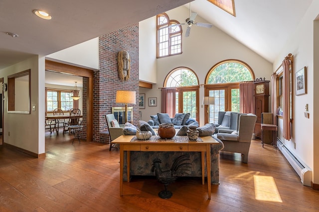 3440 Rte 44, West Windsor, VT 05037 - living area featuring baseboard heating, hardwood / wood-style floors, high vaulted ceiling, ceiling fan, and a brick fireplace