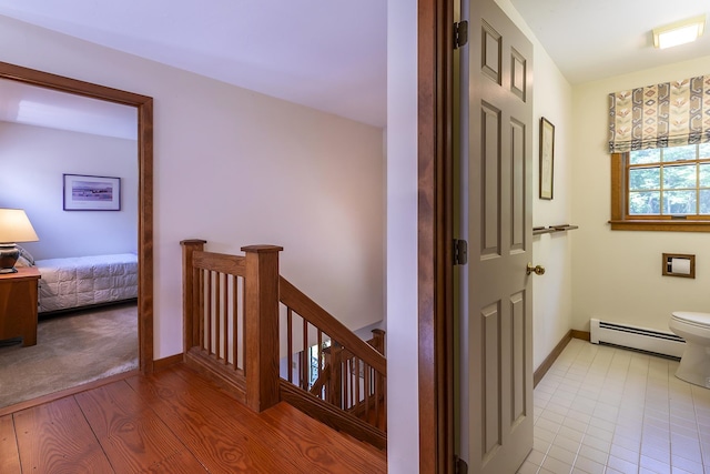 3440 Rte 44, West Windsor, VT 05037 - corridor with a baseboard heating unit, an upstairs landing, and light wood-style floors