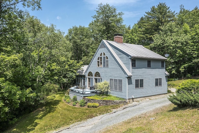 3440 Rte 44, West Windsor, VT 05037 - view of property exterior featuring a chimney, a metal roof, a yard, and driveway