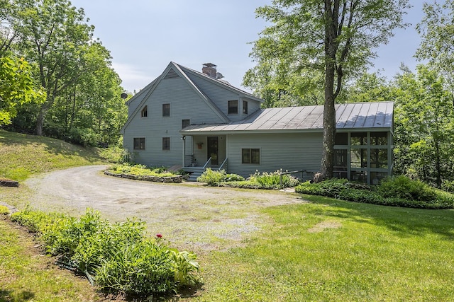 3440 Rte 44, West Windsor, VT 05037 - back of house featuring a standing seam roof, a chimney, a metal roof, a lawn, and dirt driveway