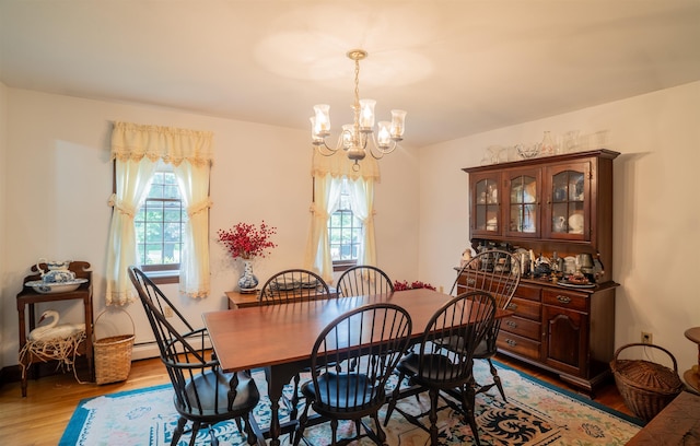 9 Oak Ridge Rd, Kensington, NH 03833 - dining space with a chandelier and light wood-style floors