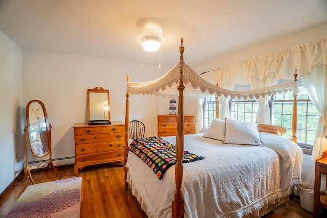 9 Oak Ridge Rd, Kensington, NH 03833 - bedroom with a baseboard heating unit and wood finished floors