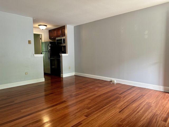 87 Cricketbrook Rd Unit 87, Dover, NH 03820 - unfurnished living room featuring wood finished floors and baseboards