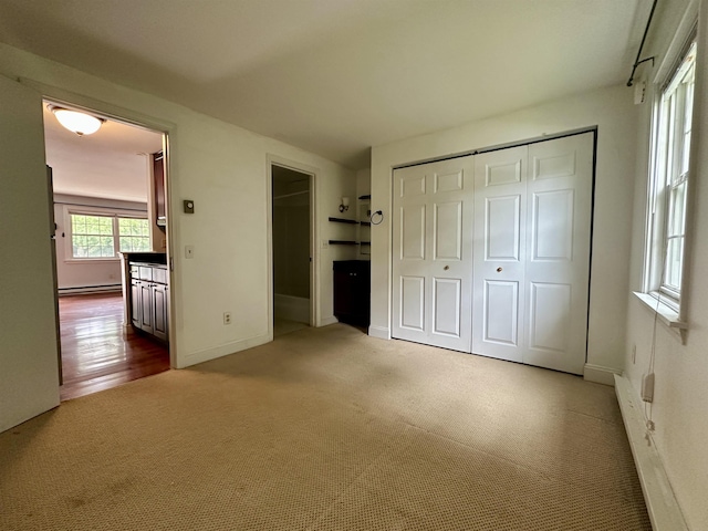 87 Cricketbrook Rd Unit 87, Dover, NH 03820 - unfurnished bedroom featuring carpet flooring, a baseboard heating unit, and a closet