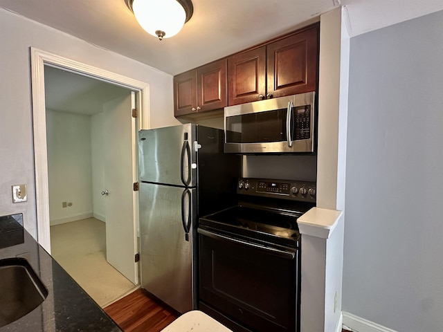 87 Cricketbrook Rd Unit 87, Dover, NH 03820 - kitchen featuring stainless steel microwave, black / electric stove, freestanding refrigerator, and dark stone counters