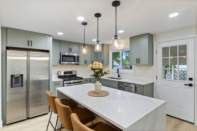 11 Bond St, Hudson, NH 03051 - kitchen featuring stainless steel appliances, light stone counters, light wood-style floors, gray cabinetry, and recessed lighting