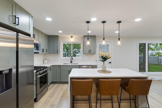 11 Bond St, Hudson, NH 03051 - kitchen with appliances with stainless steel finishes, gray cabinets, plenty of natural light, light wood-type flooring, and recessed lighting