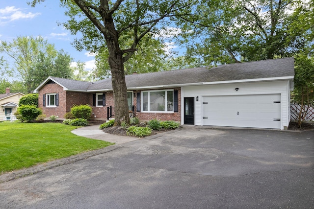 11 Bond St, Hudson, NH 03051 - single story home with brick siding, driveway, an attached garage, and a front yard