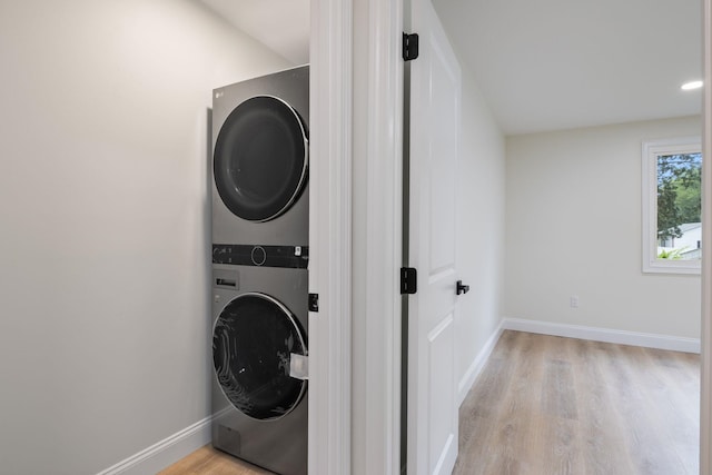 11 Bond St, Hudson, NH 03051 - laundry area with stacked washing machine and dryer and light wood-style flooring