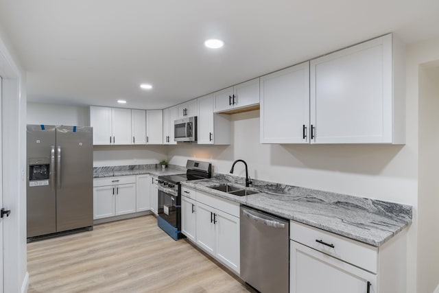 11 Bond St, Hudson, NH 03051 - kitchen with appliances with stainless steel finishes, white cabinets, light stone counters, recessed lighting, and light wood-type flooring