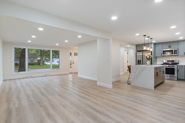 11 Bond St, Hudson, NH 03051 - kitchen featuring appliances with stainless steel finishes, gray cabinets, recessed lighting, light wood-style floors, and a kitchen island