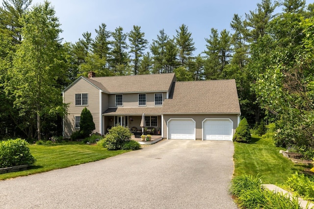 9 Strout Ln, Durham, NH 03824 - view of front of property featuring driveway, a porch, an attached garage, and a front yard