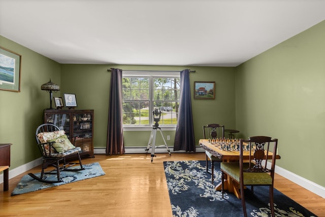 9 Strout Ln, Durham, NH 03824 - dining space featuring wood finished floors, a baseboard heating unit, and a baseboard radiator