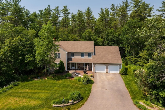 9 Strout Ln, Durham, NH 03824 - view of front of home featuring a porch, driveway, a garage, and a front lawn