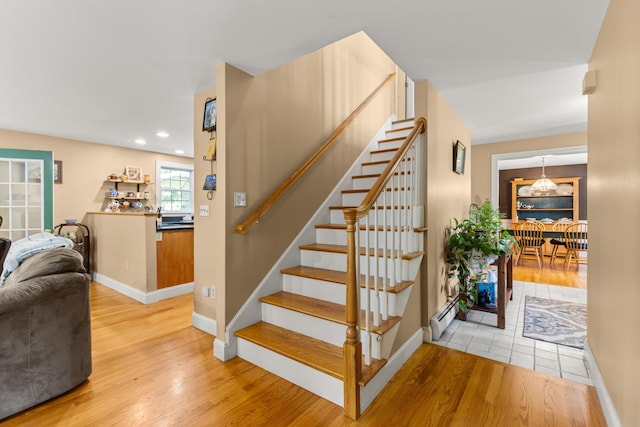 9 Strout Ln, Durham, NH 03824 - stairway featuring a baseboard radiator, wood finished floors, and recessed lighting
