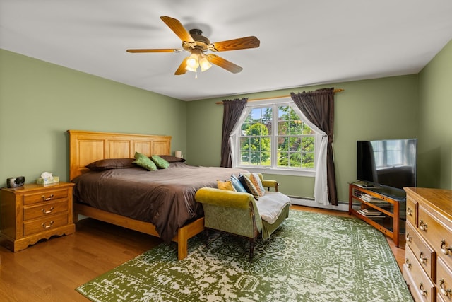 9 Strout Ln, Durham, NH 03824 - bedroom with wood finished floors, baseboard heating, and ceiling fan