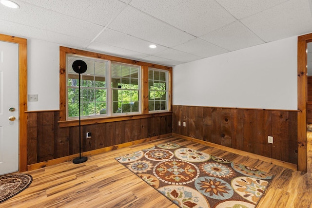 9 Strout Ln, Durham, NH 03824 - spare room with wainscoting, wood finished floors, a drop ceiling, wooden walls, and healthy amount of natural light