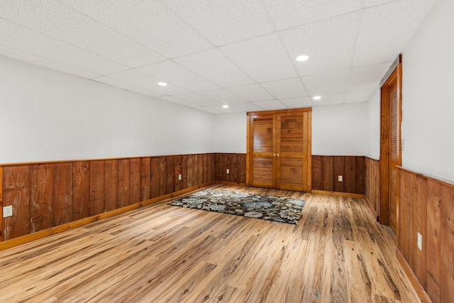 9 Strout Ln, Durham, NH 03824 - spare room with a wainscoted wall, wood finished floors, wooden walls, a drop ceiling, and recessed lighting