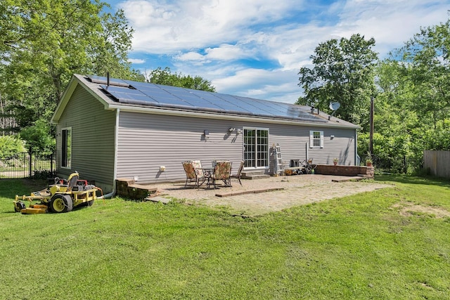 265 Lowell St, Rochester, NH 03867 - back of house featuring roof mounted solar panels, a patio area, and entry steps