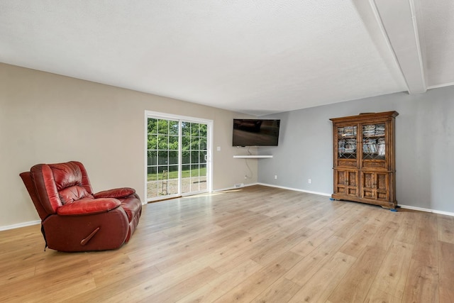 265 Lowell St, Rochester, NH 03867 - sitting room featuring light wood-type flooring and beamed ceiling