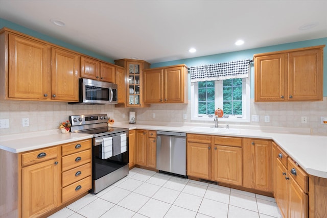 7 Partridge Cir, Salem, NH 03079 - kitchen with stainless steel appliances, tasteful backsplash, glass insert cabinets, light countertops, and recessed lighting
