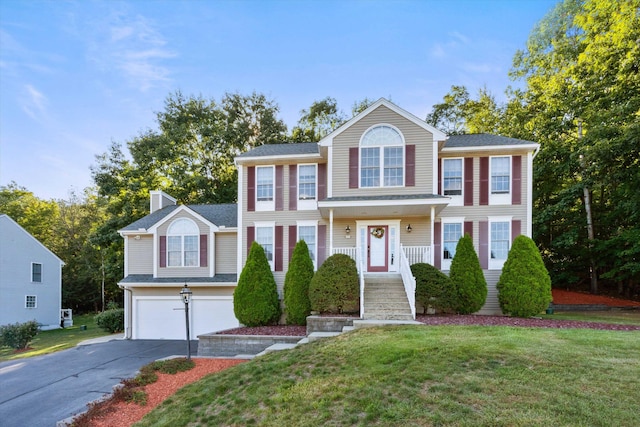 7 Partridge Cir, Salem, NH 03079 - view of front facade with concrete driveway, a garage, a front yard, and a chimney