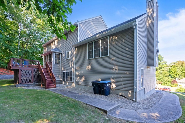 7 Partridge Cir, Salem, NH 03079 - back of property featuring a lawn, a wooden deck, a chimney, and stairs