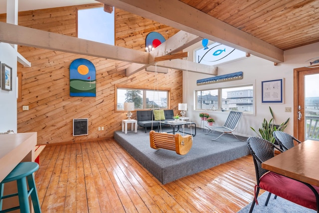 154 Cycad Ave, York, ME 03909 - living room featuring wooden walls, wood-type flooring, heating unit, and a wood ceiling with exposed beams