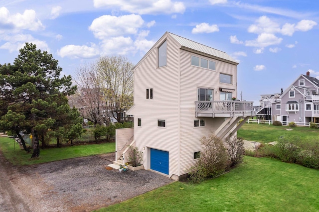 154 Cycad Ave, York, ME 03909 - view of home's exterior featuring an attached garage, stairway, a yard, gravel driveway, and a metal roof