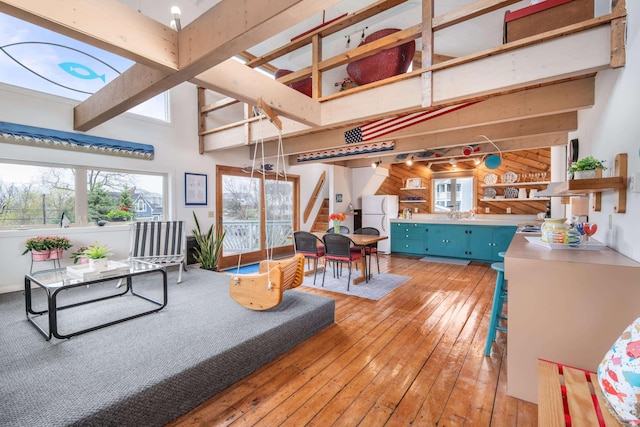 154 Cycad Ave, York, ME 03909 - living room with light wood finished floors, stairs, high vaulted ceiling, wooden walls, and beamed ceiling