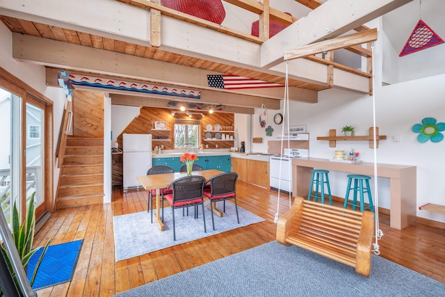 154 Cycad Ave, York, ME 03909 - dining space with beamed ceiling, wood-type flooring, and stairs