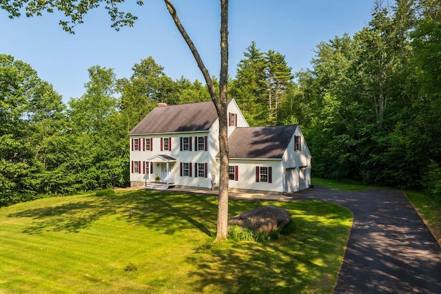 23 Stone Farm Rd, Barrington, NH 03825 - colonial inspired home with a front yard, a porch, a chimney, and a detached garage