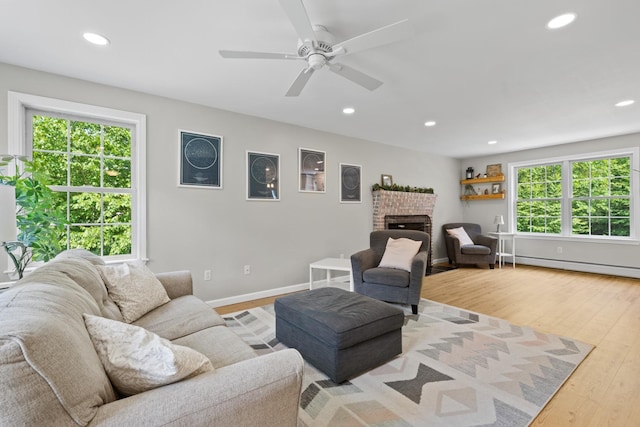 23 Stone Farm Rd, Barrington, NH 03825 - living area with recessed lighting, wood finished floors, a brick fireplace, ceiling fan, and baseboard heating