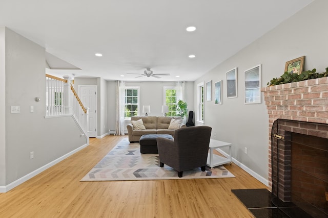 23 Stone Farm Rd, Barrington, NH 03825 - living room with stairs, a brick fireplace, light wood-style floors, recessed lighting, and a ceiling fan