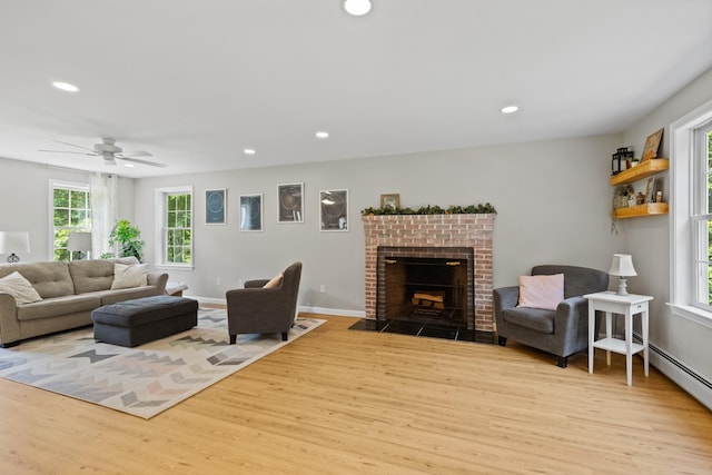 23 Stone Farm Rd, Barrington, NH 03825 - living room featuring light wood-style flooring, recessed lighting, a brick fireplace, a ceiling fan, and baseboard heating