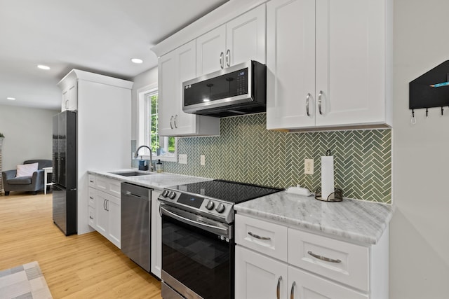 23 Stone Farm Rd, Barrington, NH 03825 - kitchen featuring stainless steel appliances, light wood-style flooring, white cabinetry, backsplash, and recessed lighting