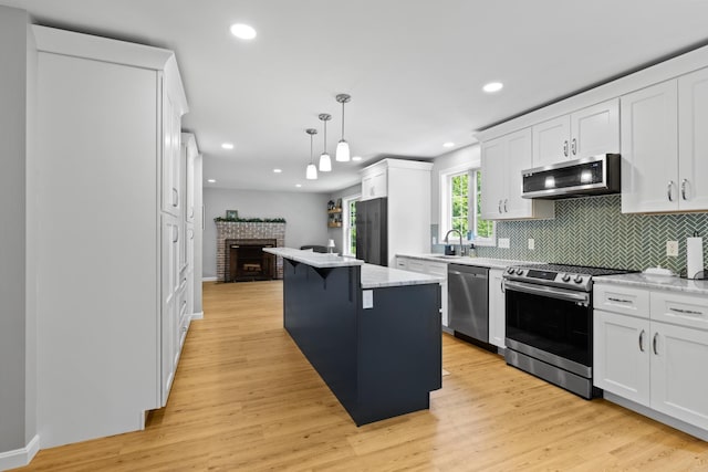 23 Stone Farm Rd, Barrington, NH 03825 - kitchen featuring stainless steel appliances, white cabinetry, decorative backsplash, a center island, and recessed lighting
