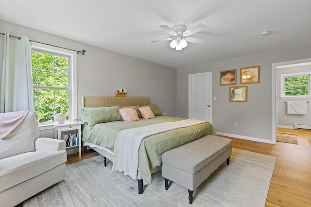 23 Stone Farm Rd, Barrington, NH 03825 - bedroom with wood finished floors, a baseboard radiator, and ceiling fan
