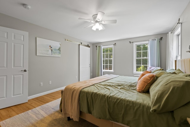 23 Stone Farm Rd, Barrington, NH 03825 - bedroom featuring wood finished floors, a barn door, and a ceiling fan