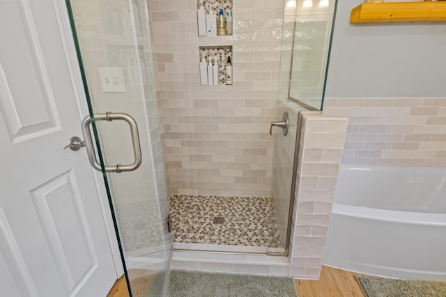 23 Stone Farm Rd, Barrington, NH 03825 - full bathroom with a shower stall, a bath, and wood finished floors