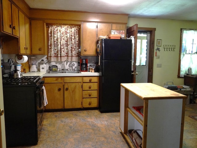 2505 County Rd, Windsor, VT 05089 - kitchen featuring black appliances, decorative backsplash, stone finish flooring, and brown cabinets