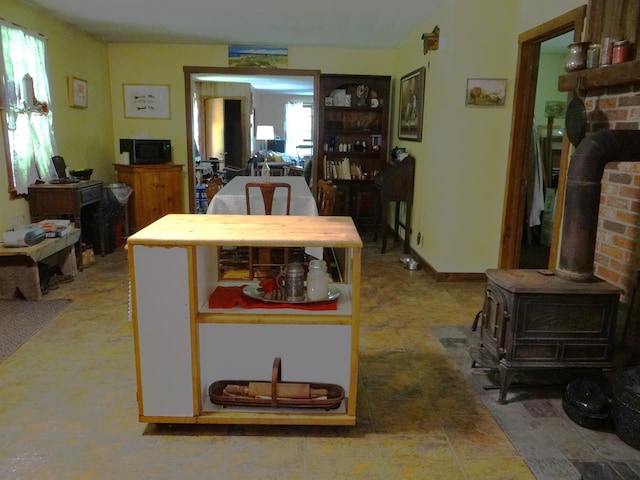 2505 County Rd, Windsor, VT 05089 - kitchen featuring black microwave and a wood stove