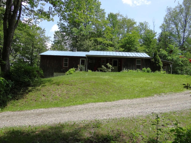 2505 County Rd, Windsor, VT 05089 - view of front of house with a metal roof, board and batten siding, a chimney, a front lawn, and a carport