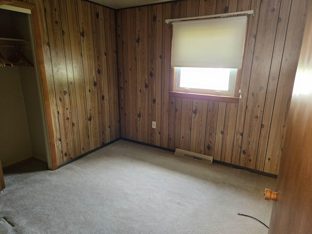 9 Mariette Dr, Portsmouth, NH 03801 - unfurnished bedroom with carpet, wooden walls, and a closet
