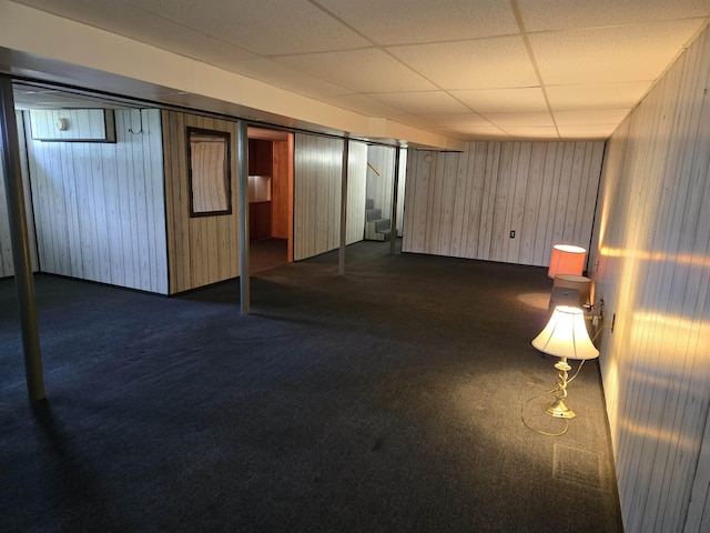 9 Mariette Dr, Portsmouth, NH 03801 - finished below grade area with stairway, dark carpet, a paneled ceiling, and wood walls